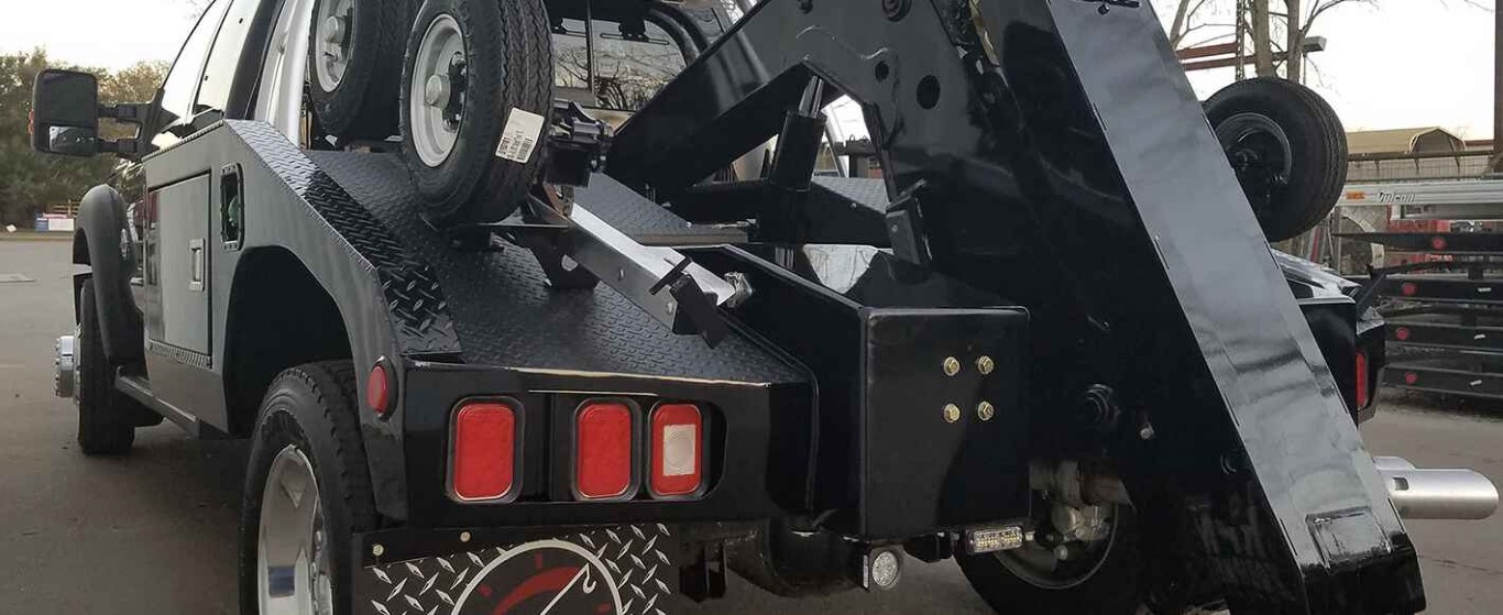 Tow truck providing jump start service to a stranded vehicle in West Babylon, NY