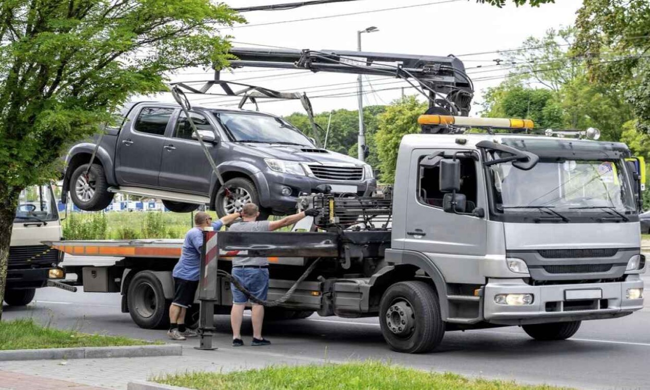 Tow truck loading a pickup truck for accident recovery in West Babylon, NY